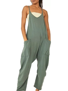 Detail view of dark green jumpsuit with thin straps and large side pockets