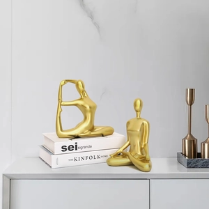 Elegant gold yoga figures in meditation poses for modern minimalist home decor