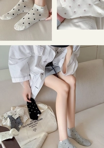 Detailed close-up of dot pattern cotton socks in various neutral colors for daily wear