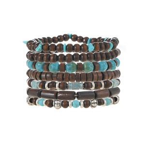 Detail view of layered wood beads and turquoise stone bracelets with metal spacers