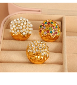 Macro shot of heart-shaped earrings with pearls and colorful rhinestones in a jewelry box