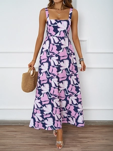 Detail of floral print maxi dress featuring square neck design and woven handbag accessory