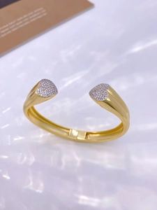 Macro shot of double heart open ring featuring gold plating and white zircon inlay