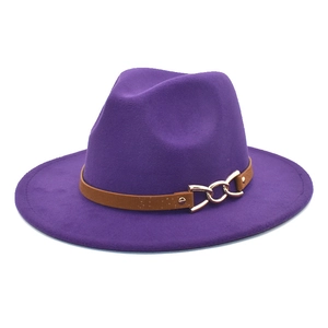 Detail of purple fedora hat featuring a brown faux leather band and gold metal chain