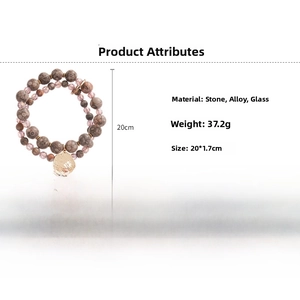 Detail of beaded double-layer bracelet with leopard stone beads and gold leaf charm