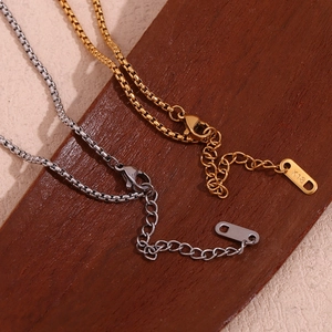 Detail of 18K gold and silver box chains with K18 engraving and lobster clasp