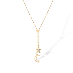 Close-up of a gold-plated necklace with a shell-inlaid star and crescent moon pendant