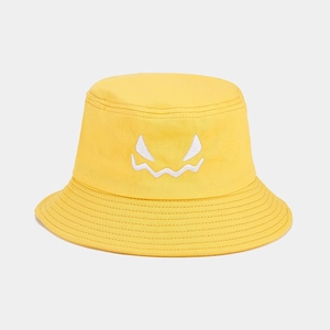 Detail of yellow cotton bucket hat with white embroidered monster face and stitched brim
