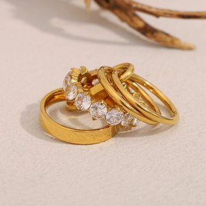 Detailed view of layered 18K gold plated rings with sparkling white zircon insets