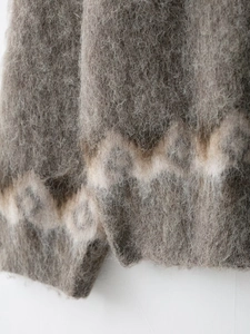 Close-up of fuzzy mohair blend knitwear featuring vintage wave pattern and plush texture