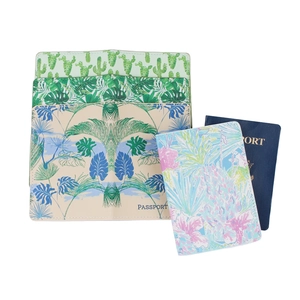 Detail of PU leather passport covers featuring tropical palm leaf and pineapple prints