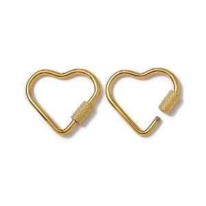 Detail of gold heart-shaped screw lock carabiner showing open and closed states
