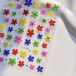 Macro shot of colorful floral nail stickers with sparkling crystal diamond centers
