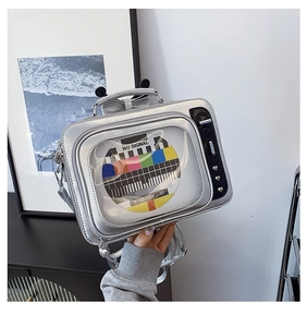 Detail of silver TV shaped crossbody bag featuring retro test pattern screen and Y2K style