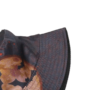 Detailed view of bucket hat featuring artistic cloud print and reinforced stitching