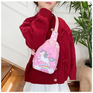 Pink unicorn pattern crossbody bag shown on a young girl in a cozy indoor setting