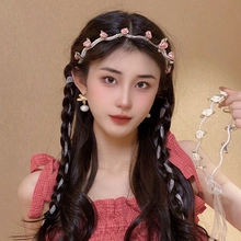 Close-up of pink rose flower hair clip on braided hair with delicate woven details
