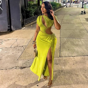 Detail of lime green hollow-out dress showing waist cut-out and high slit leg design