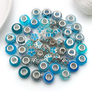 Detailed flat lay of assorted lake blue alloy beads with rhinestones for DIY jewelry