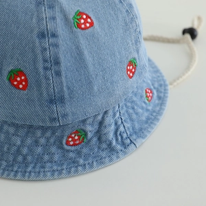 Blue denim toddler bucket hat with strawberry embroidery and adjustable chin strap