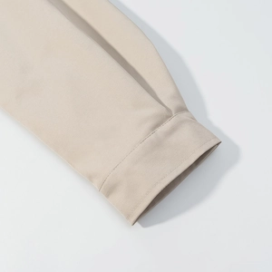 Close-up of high-quality beige jacket sleeve cuffs with professional stitching details