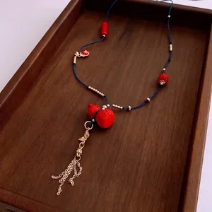 Retro cinnabar gourd pendant necklace with golden tassels and blue braided cord