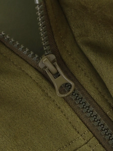 Detail shot of the durable olive green zipper and high-quality fabric on the jacket
