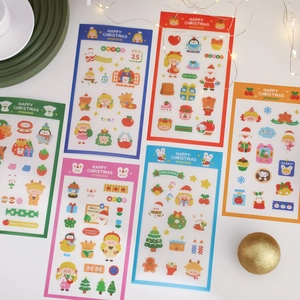 Flat lay of colorful Christmas cartoon stickers with Santa patterns for scrapbooking