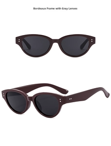 Detail view of Bordeaux cat-eye sunglasses with gray lenses and silver hinge accents