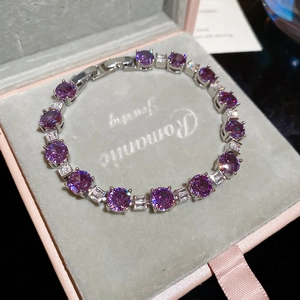 Detail of purple cubic zirconia bracelet with silver clasp on pink jewelry box