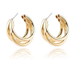 Close-up of golden multi-layer C-shaped hoop earrings with a triple-layered overlapping design
