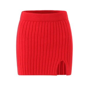 Close-up of red ribbed knit mini skirt featuring a stylish side slit detail