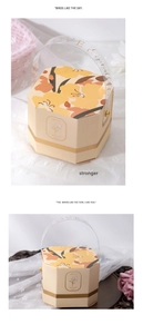 Macro view of hexagonal floral candy box with elegant golden text on a clear handle