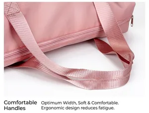 Detailed close-up of soft pink nylon webbing handles on a large travel fitness bag