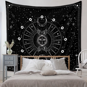 Detail of bohemian mandala tapestry featuring sun and moon patterns in a modern bedroom