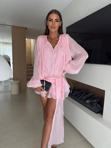 Detail of pink chiffon dress featuring V-neck ties, lantern sleeves and silky fabric texture