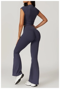 Detail of high-waisted flare leggings and back-cutout crop top in deep purple