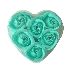 Detailed top view of six teal soap roses inside a heart-shaped transparent gift box