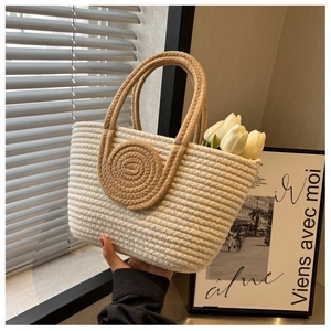 Detail of handwoven cream cotton tote with contrast brown handles in a cozy setting