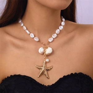 Vintage gold layered necklace with baroque pearls, seashell and starfish pendant on model