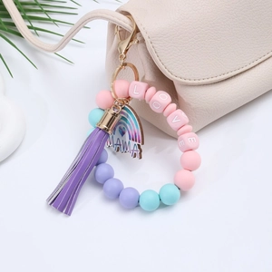 Silicone bead keychain bracelet with LOVE beads and MAMA charm hanging on a bag