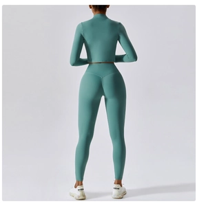 Back view of mint green high-waisted yoga leggings and long sleeve cropped sports jacket