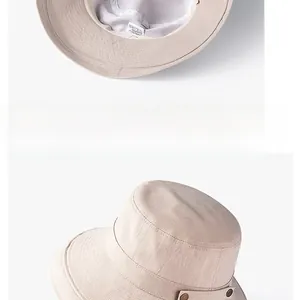 Détail du chapeau de soleil beige montrant la texture en lin et l'étiquette intérieure