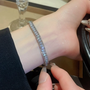 Detail of silver rhinestone chain bracelet showing triple-row pave setting on wrist