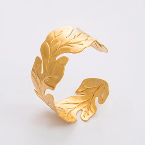 Detailed view of the golden leaf texture on this elegant adjustable stainless steel bangle