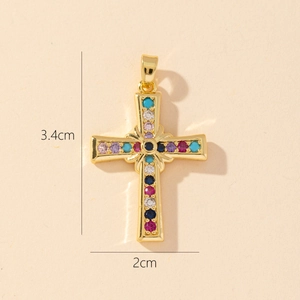 Detail of a gold plated cross pendant with multi-color zircons showing 3.4cm by 2cm size
