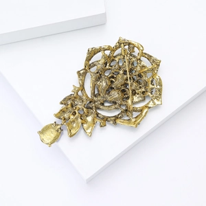 Detail view of the vintage gold flower brooch back showing the secure pin fastener