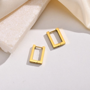 Elegant gold-plated octagon hoop earrings in stainless steel on silk background