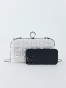White beaded bridal clutch bag shown with a smartphone to demonstrate the compact size