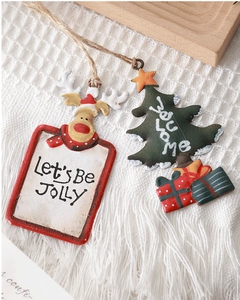 Detail of vintage hand-painted metal Reindeer and Christmas Tree hanging ornaments